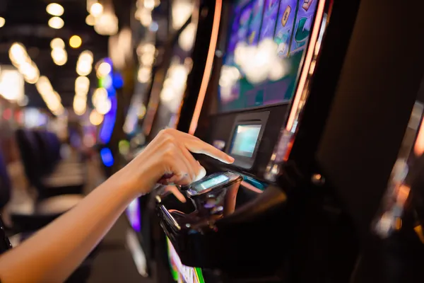 A young woman relaxing with her phone while dynamic casino elements float around her, illustrating the smooth mobile experience offered by the OLYMP app.