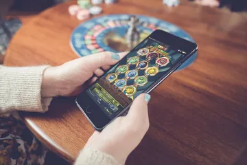 A stylish woman beside vibrant slot machines displaying glowing sevens, showcasing the variety of top slots at OLYMP.
