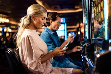 OLYMP Games — Discover modern slots and table adventures A man celebrating a winning moment on his laptop while gaming symbols float around him, capturing the excitement of OLYMP games.