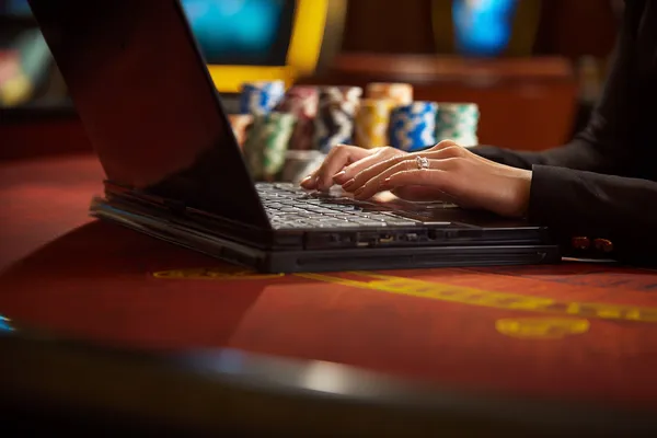 OLYMP Live Games — Take part in high-energy casino action A glowing roulette wheel with cascading chips, symbolizing the engaging live and instant-win games available on OLYMP.